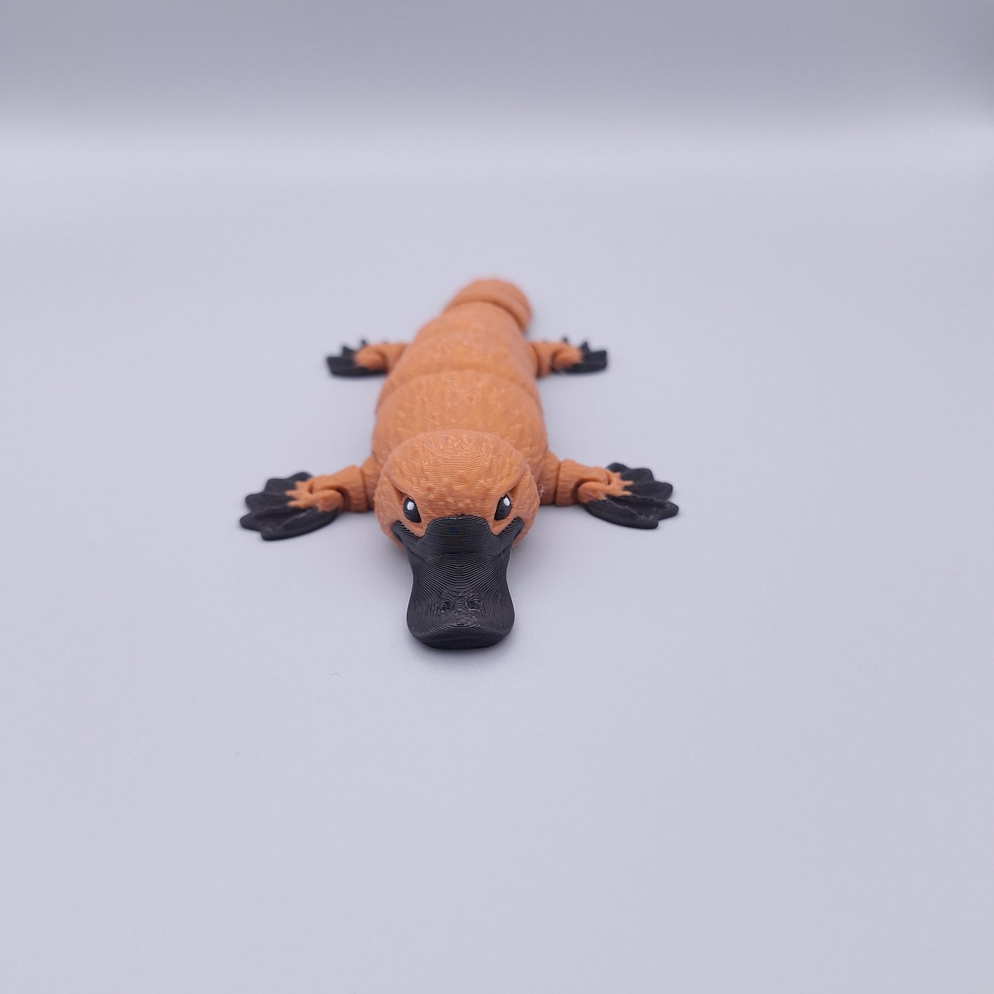 Realistic articulated platypus fidget toy with wide bill and sculpted limbs