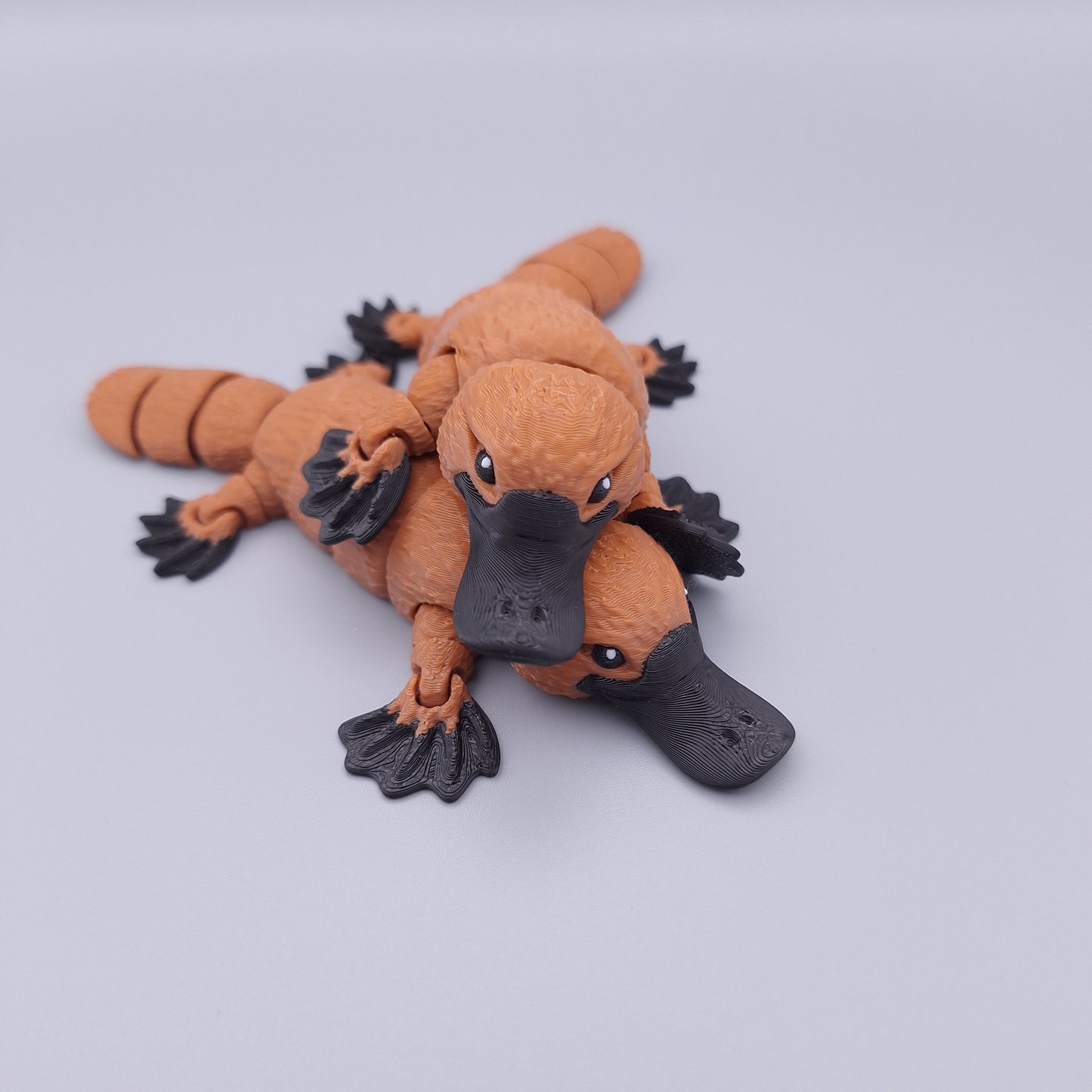 Realistic articulated platypus fidget toy with wide bill and sculpted limbs