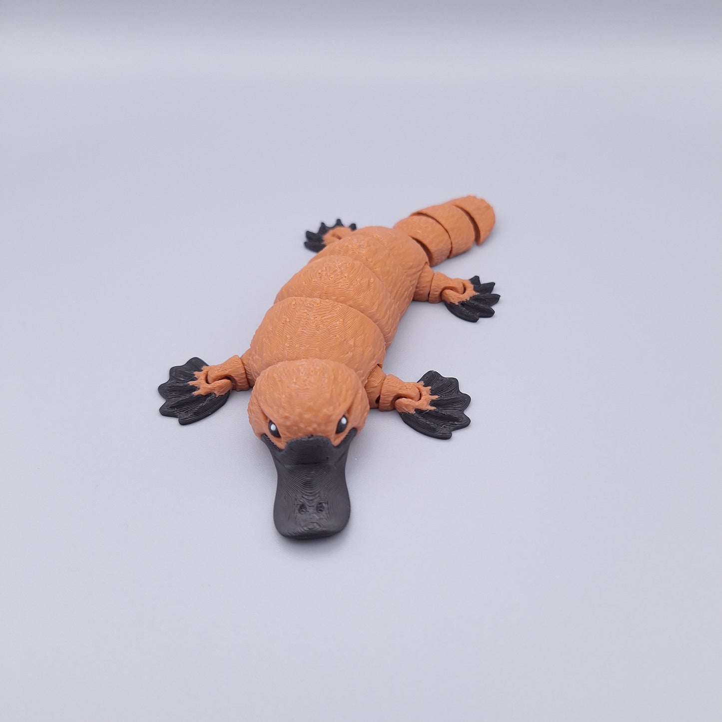 Realistic articulated platypus fidget toy with wide bill and sculpted limbs