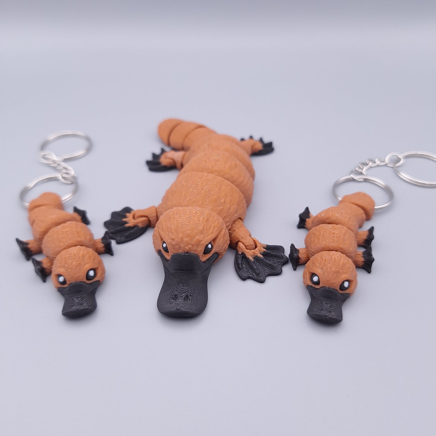 Realistic articulated platypus fidget toy with wide bill and sculpted limbs and platypus keychain